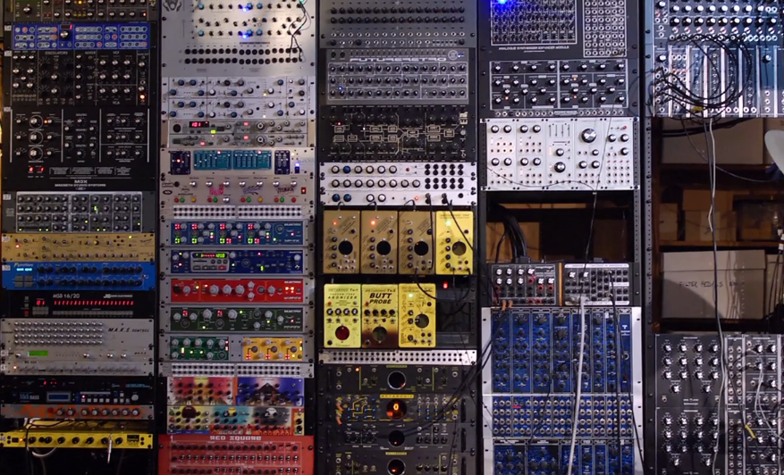 lots of modular synthesizer components connected with wires